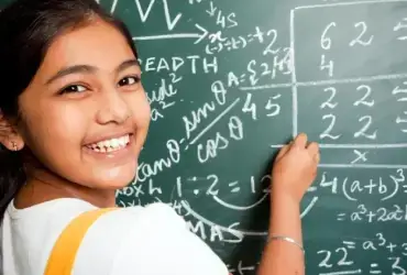 girl student solving problem on board