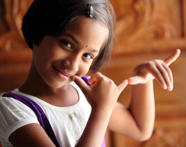 a girl showing flute symbol with her hand